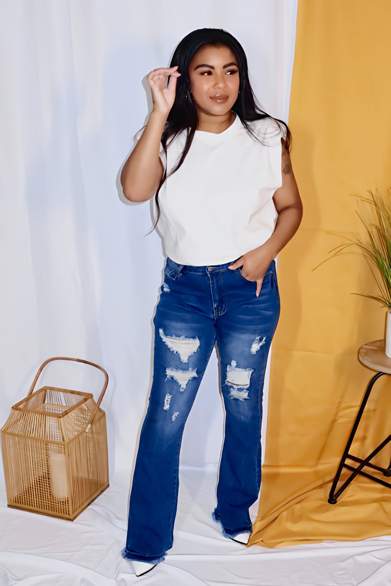 flare legged blue jeans with light tearing on them